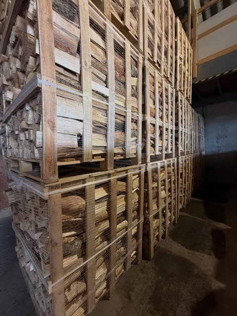 Crates of kiln-dried firewood loaded into a freight container