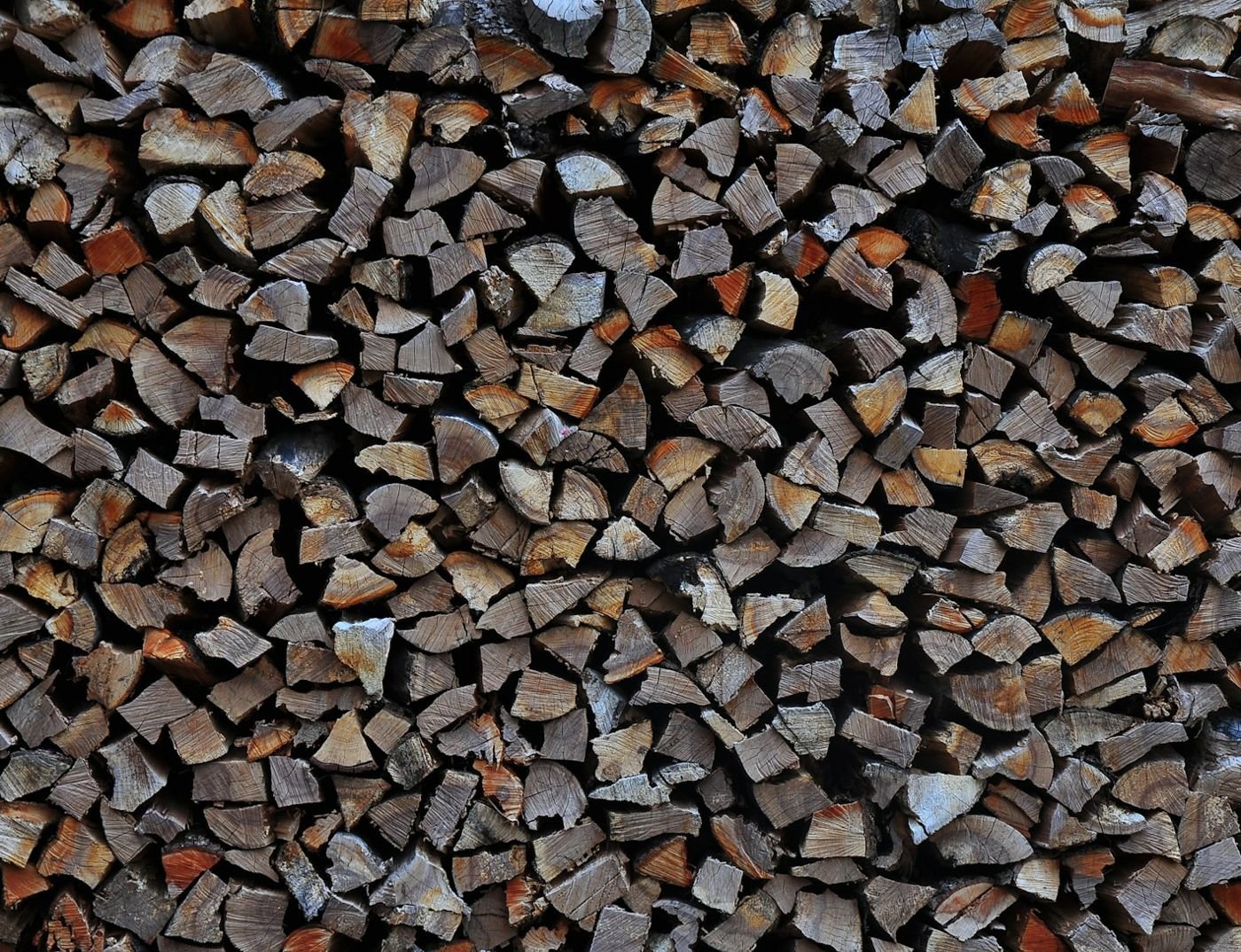 Wall of stacked kiln-dried firewood, split ends facing out